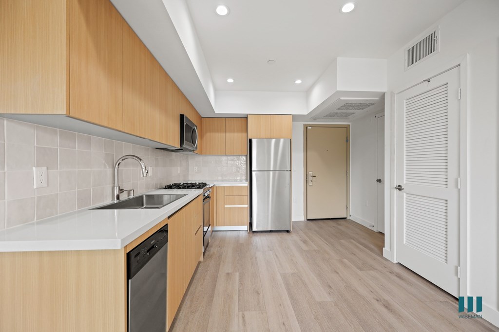 A kitchen with wooden cabinets and a white countertop.