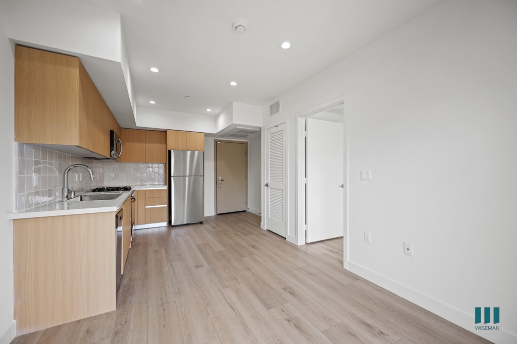 A kitchen with wooden cabinets and a white countertop.