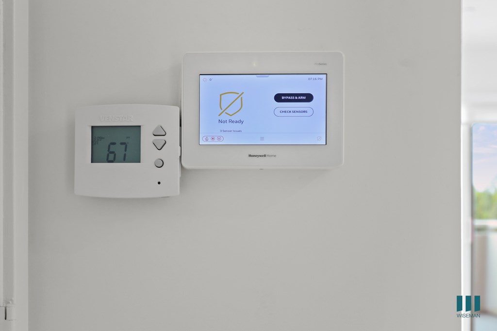 A Velociti thermostat is on a wall with a screen that says Not Ready.