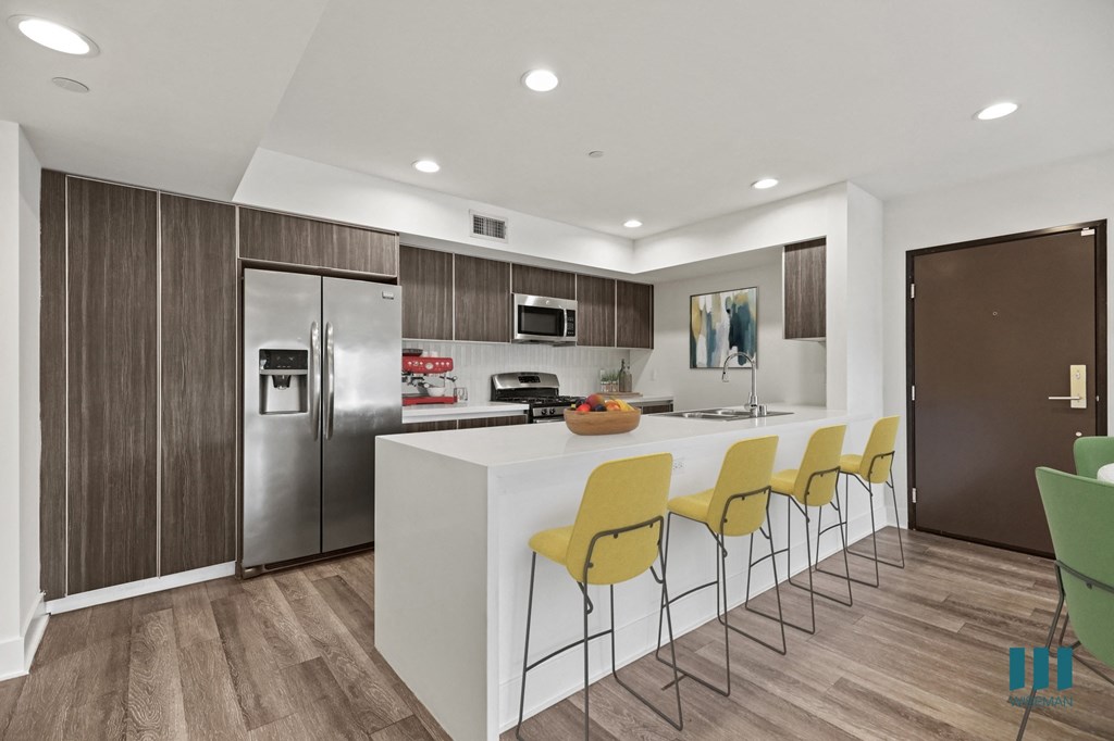 Kitchen with Energy-Efficient Appliances and Ample Cabinet Storage and Countertop Bar Kitchen with Energy-Efficient Appliances and Ample Cabinet Storage and Countertop Bar