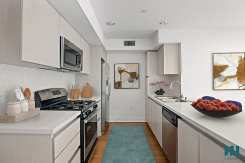 a kitchen with a sink and a stove and a microwave