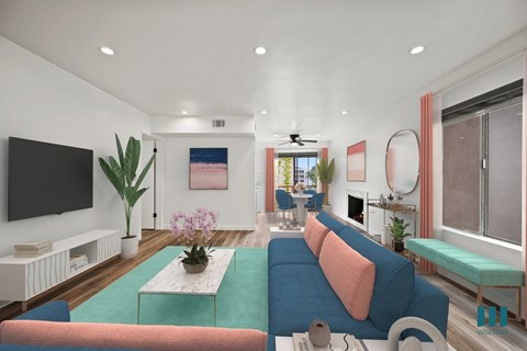A living room with a blue couch and a television on the wall.