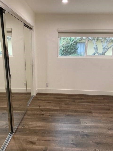 Bedroom with Mirrored Closet and Recessed Lighting