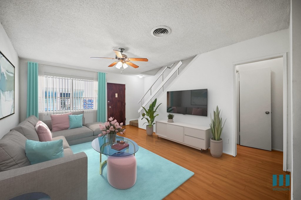 Entryway and Living Room with a Stairwell to the Upper Level of a Townhome