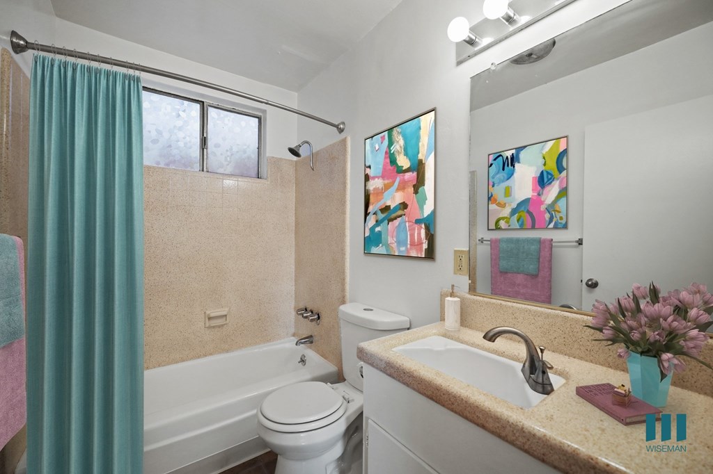 Bathroom with Shower Bath, Window, and Vanity Cabinet Storage