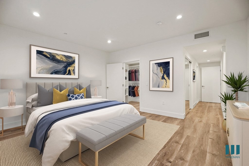 Spacious Bedroom with Walk-In Closet, Vinyl Flooring, and Recessed Lighting Spacious Bedroom with Walk-In Closet, Vinyl Flooring, and Recessed Lighting