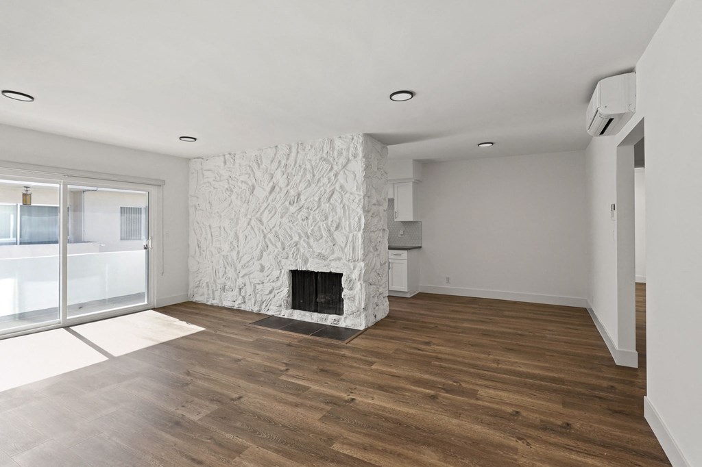 Living Room with Electric Fireplace, Vinyl Flooring, and Patio