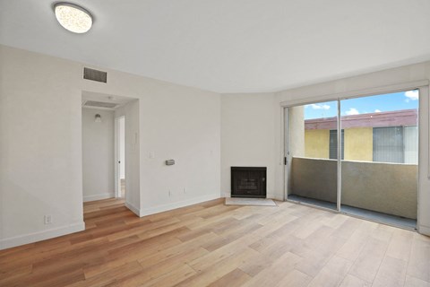 Living Room with an Electric Fireplace, Vinyl Flooring, and Balcony
