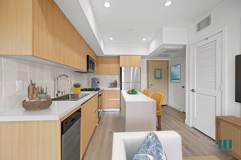 A modern kitchen with wooden cabinets and a white countertop.