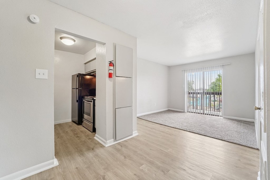 A kitchen area with a refrigerator and oven.