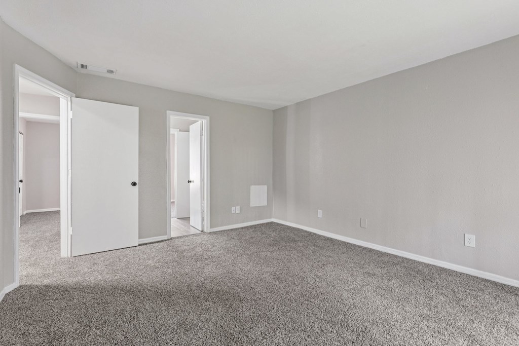 A room with carpeted floor and white walls.