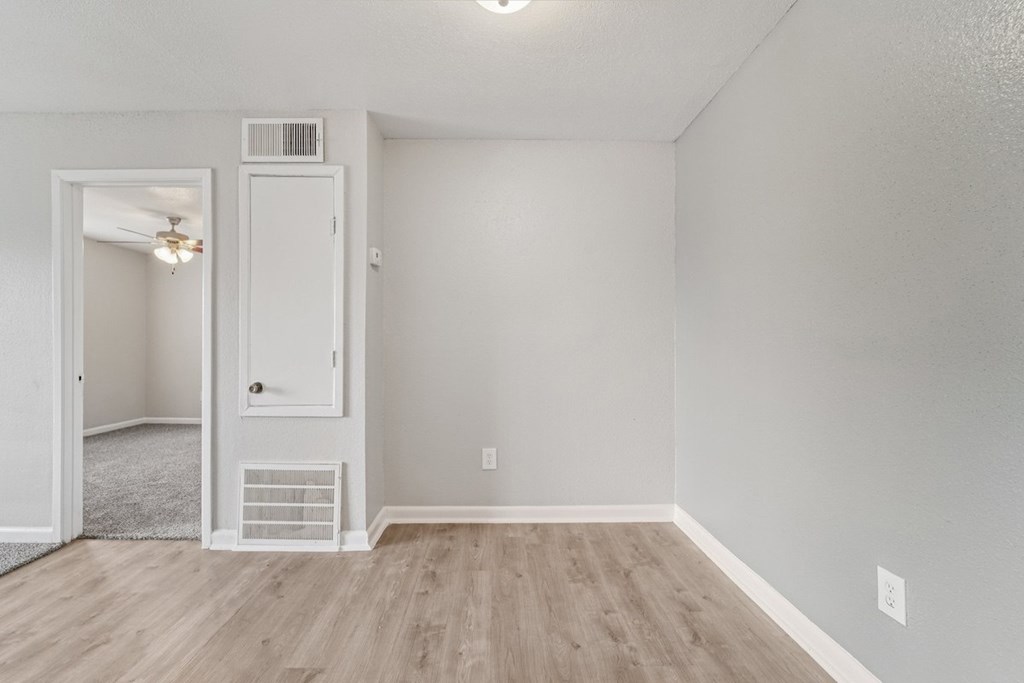 A room with a white door and a window.