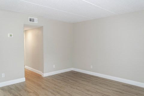 Ridge's one-bedroom floor plan's living room with wood-style flooring
