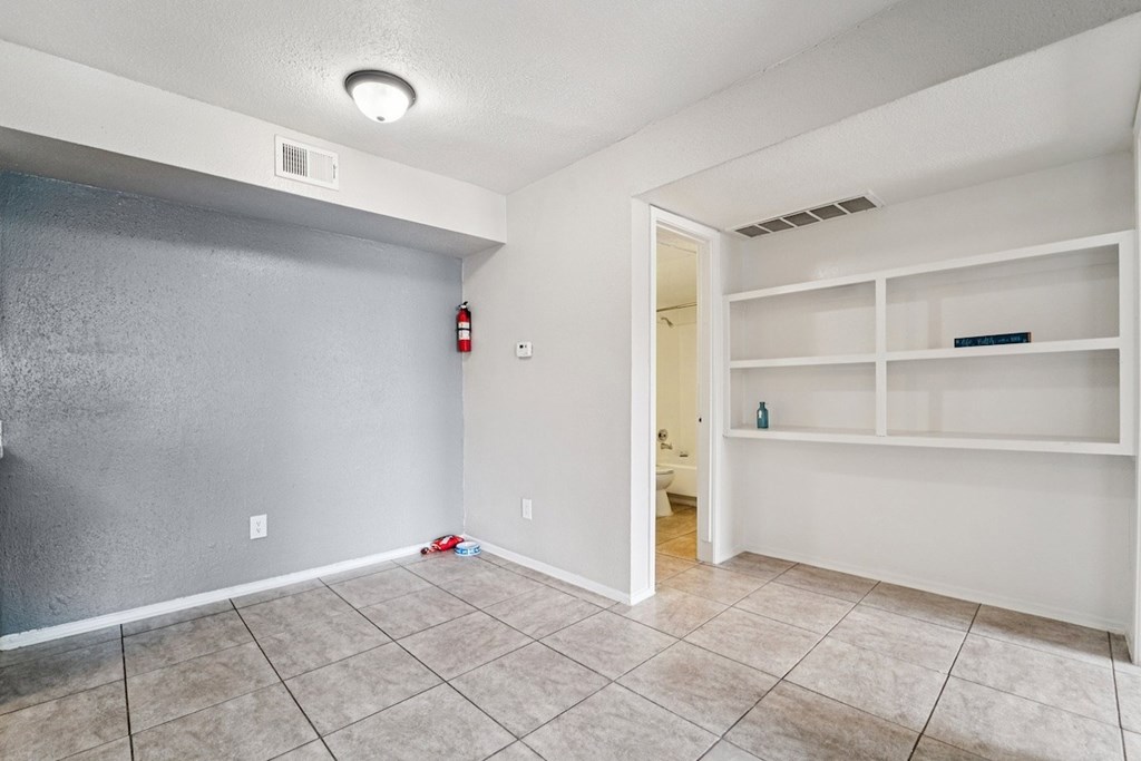 A room with a fire extinguisher on the wall.