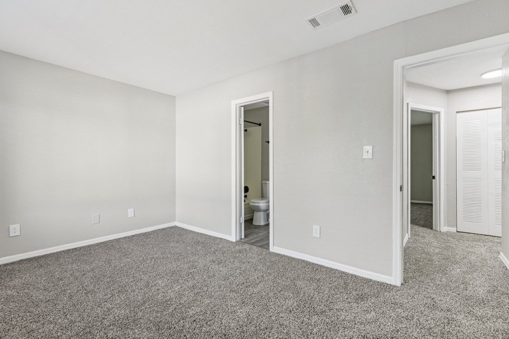 A room with carpeted floor and white walls.