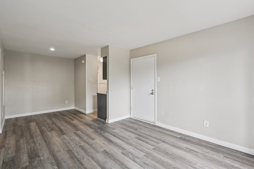 A room with a white door and a white wall.