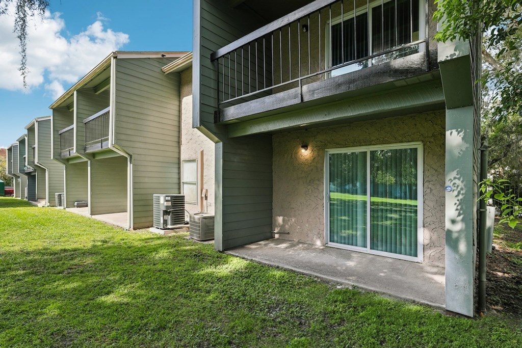 A row of houses with green lawns in front.