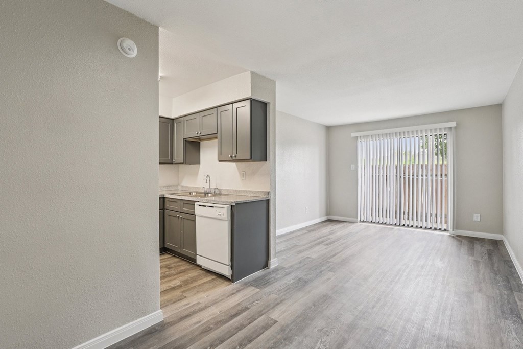 A kitchen with a white dishwasher and a white fridge.
