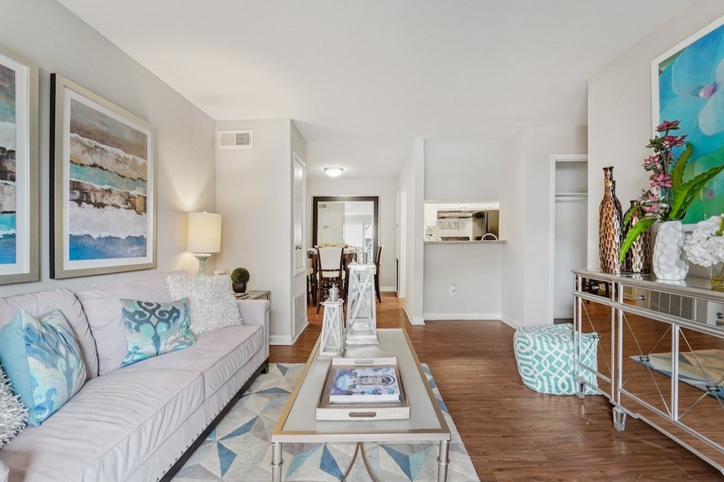 A living room with a white couch and a coffee table.