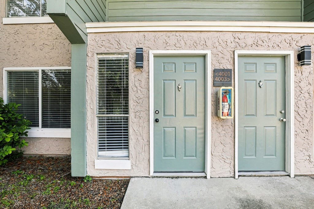 A house with two doors and a mailbox on the right.