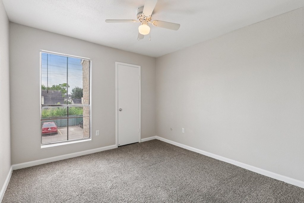 A room with a car parked outside the window.