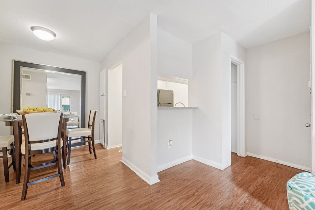 A dining room with a table and chairs.