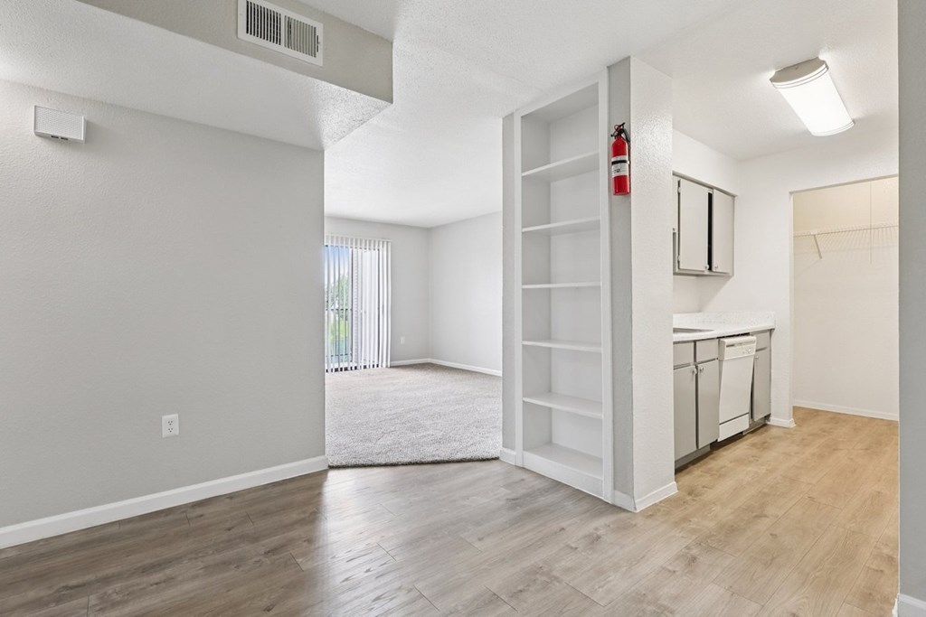 A room with a white door and a window with blinds.