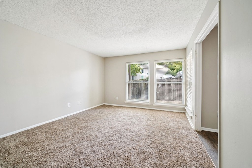 A room with a carpeted floor and a window with blinds.at Hills at Hoover Apartments, Hoover, 35216