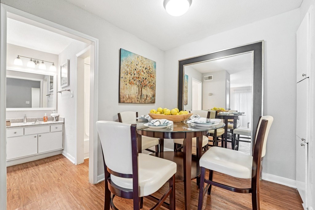 A dining room with a wooden table and chairs.