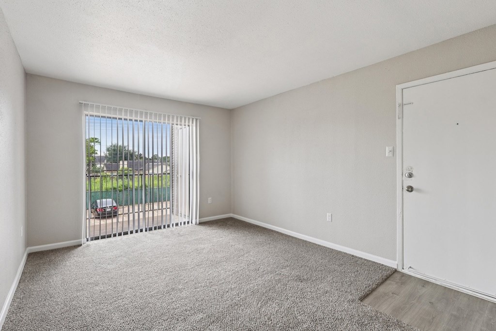 A room with a car parked outside the window.