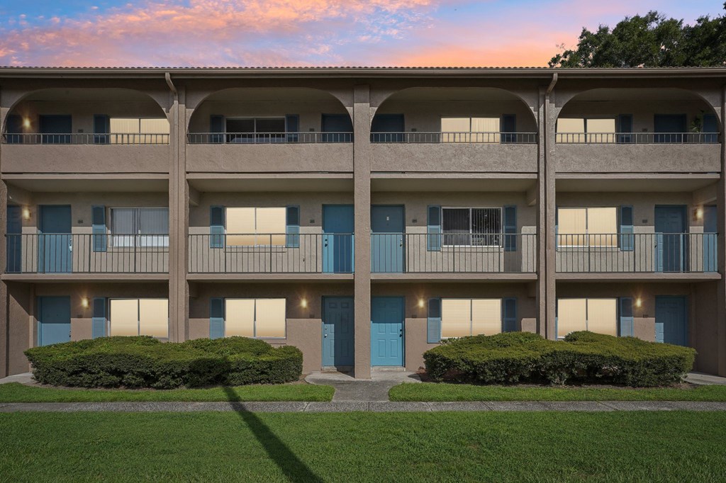 Apartment building with blue doors and windows.