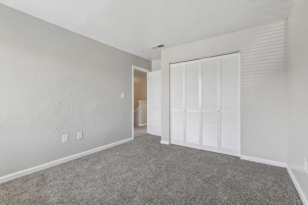 A room with white walls and a carpeted floor.