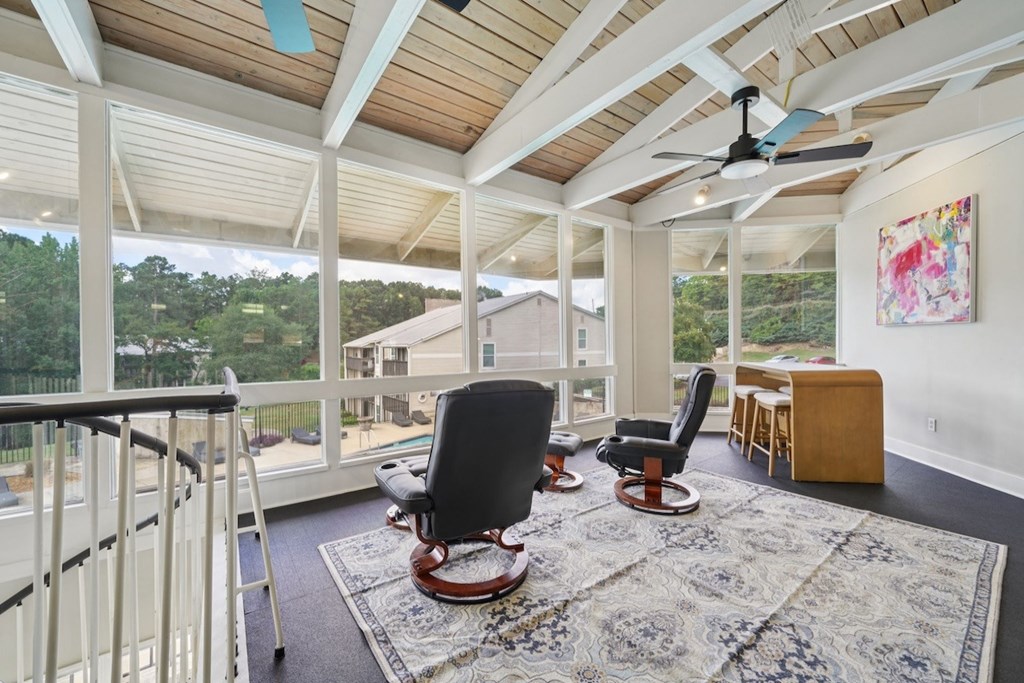 A room with a ceiling fan and a chair.at Hills at Hoover Apartments, Hoover Alabama