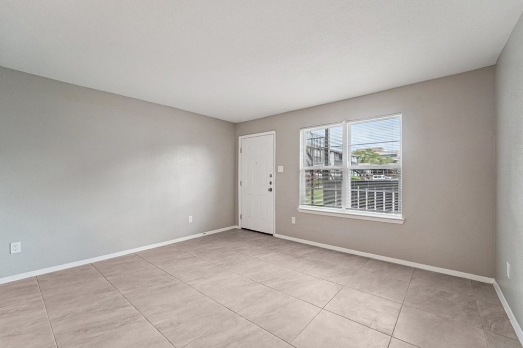 Empty room with a window and a door.