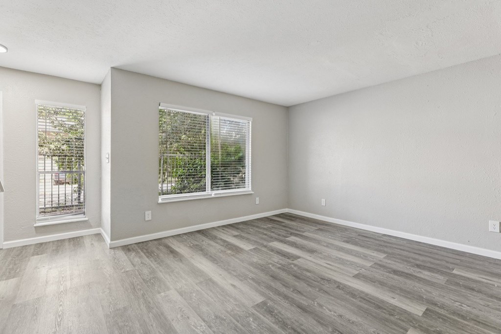 A room with a window and a door leading outside.