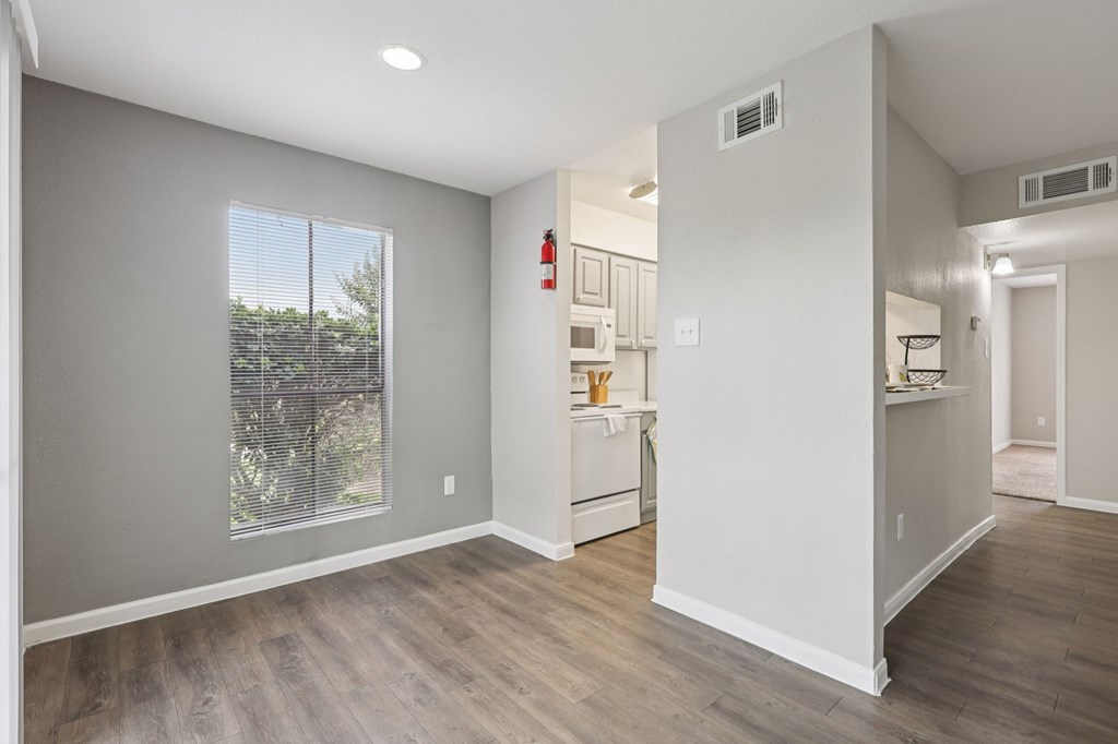 A room with a window and a kitchenette.