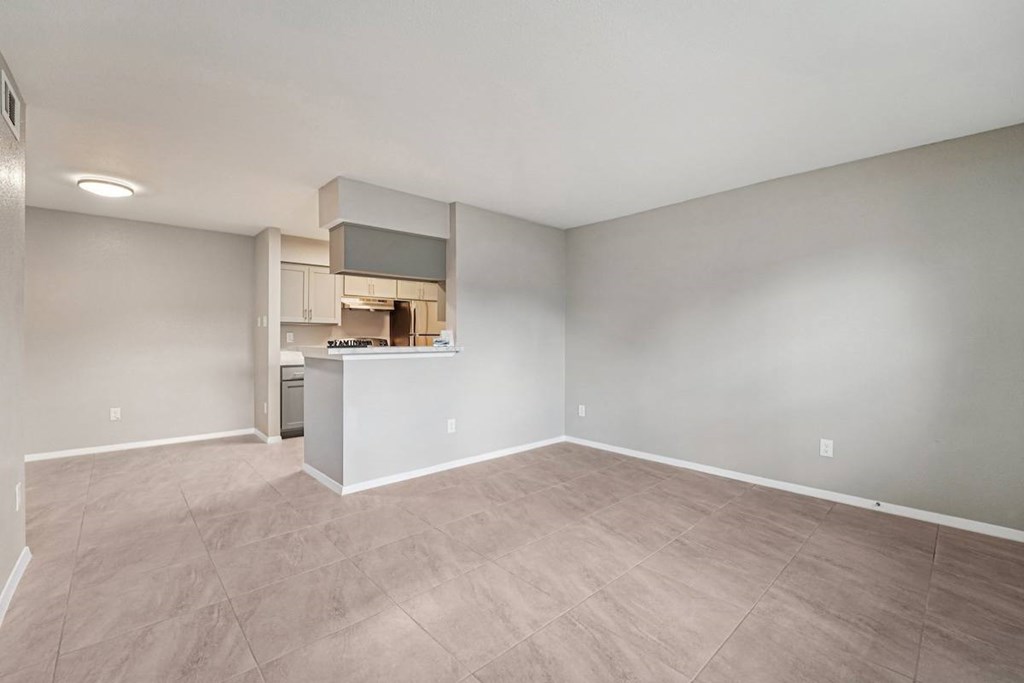 A kitchen area with a white countertop and cabinets.