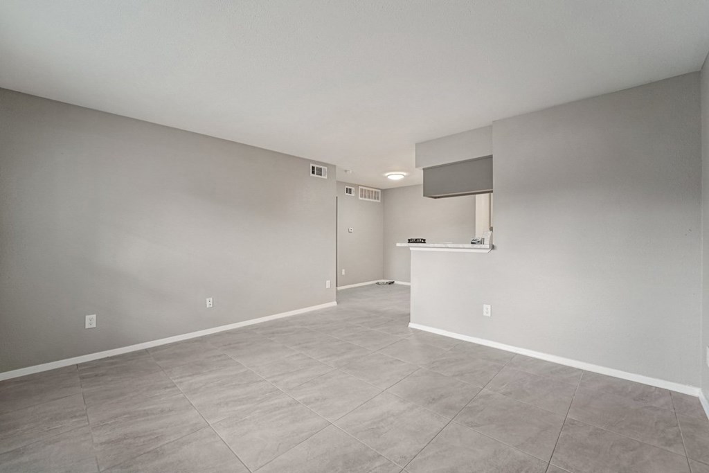 A spacious room with a door and a window.