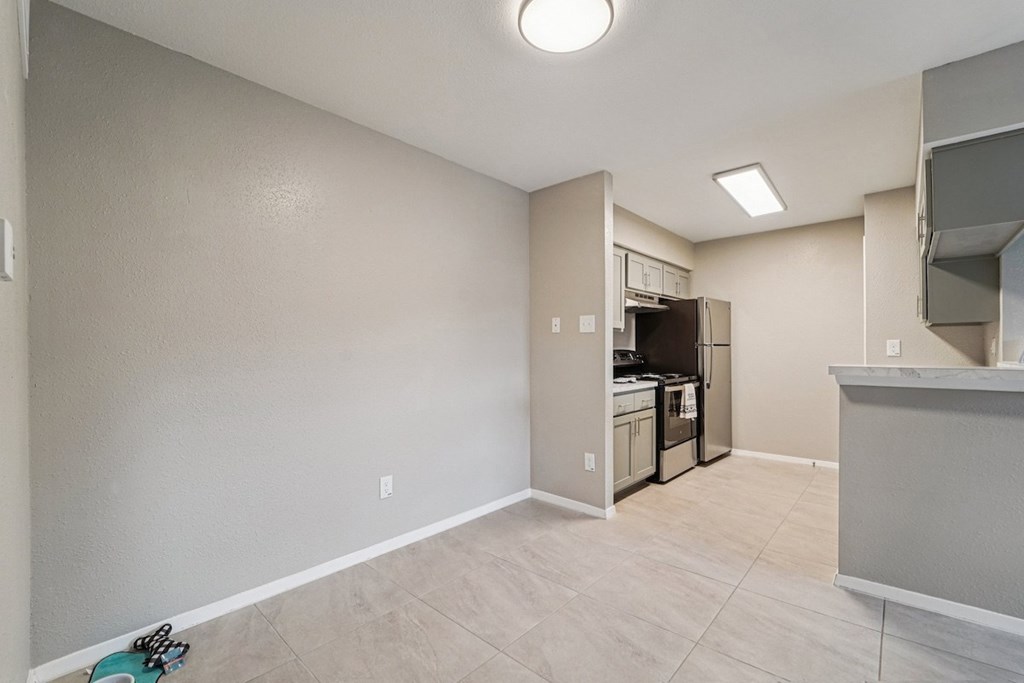 A kitchen area with a refrigerator, oven, and microwave.