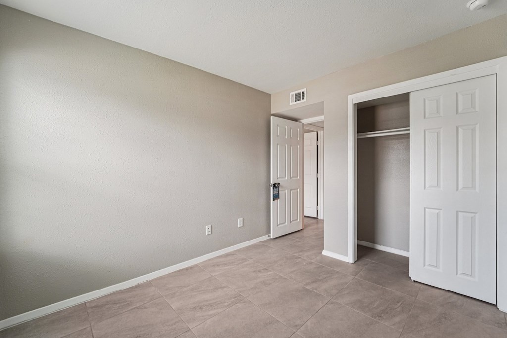 A room with a white door and a wall socket.