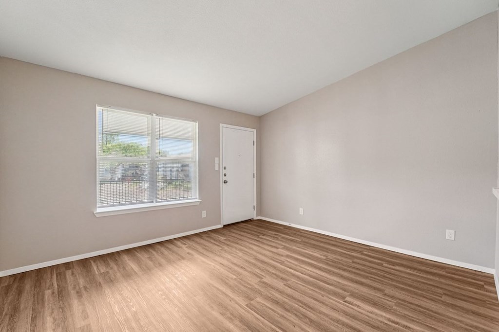 A room with a window and a door.