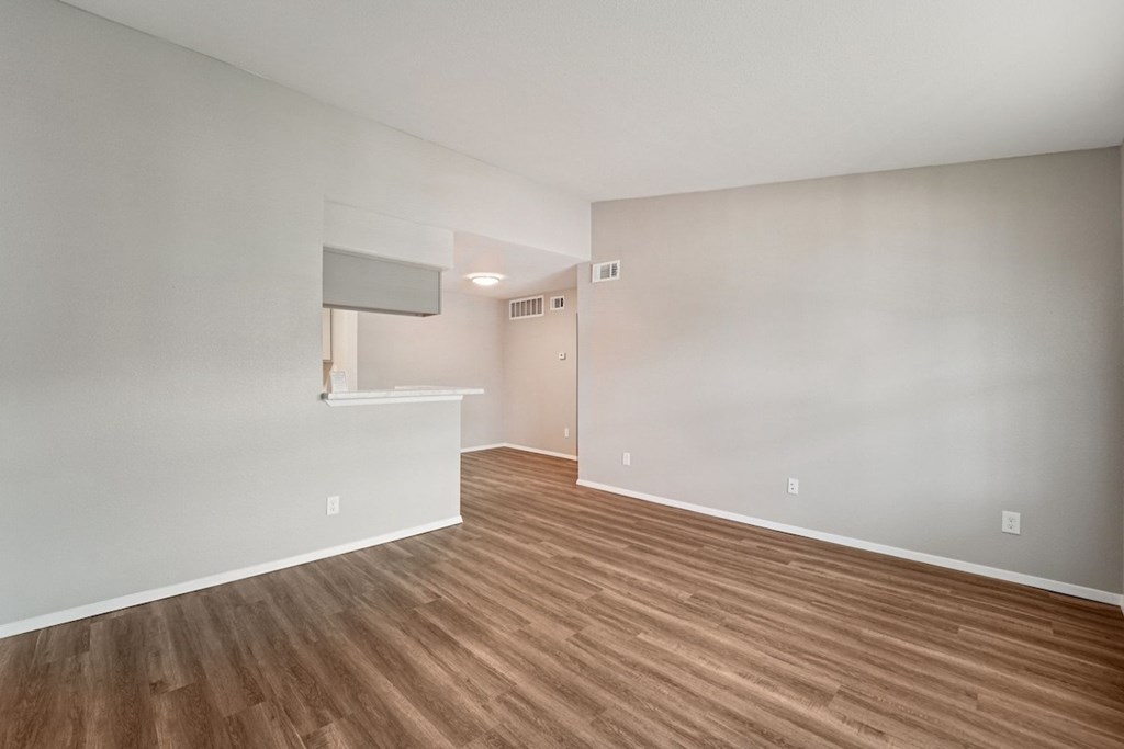 A room with wooden flooring and a window.