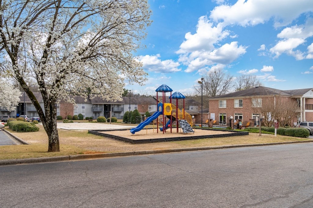 a playground in the middle of a street with houses a playground in the middle of a street with houses at Ascot Place Apartments, Birmingham, AL 35235