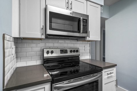a kitchen with a stove and a microwave