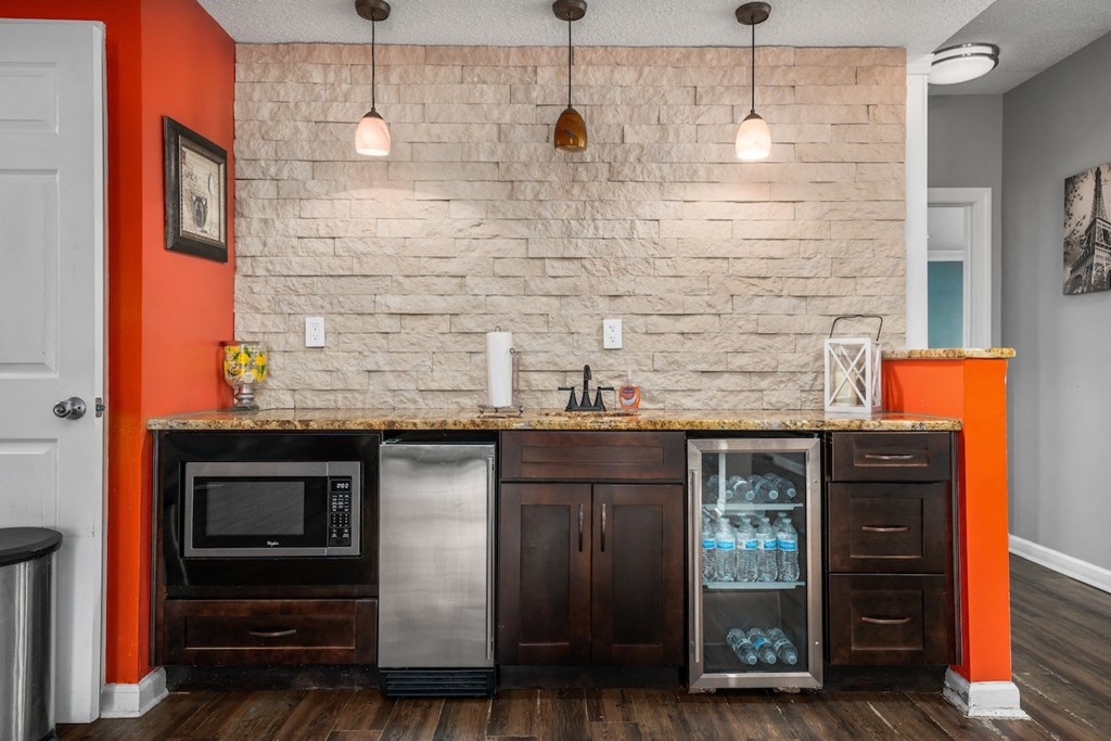 a kitchen with a counter with a refrigerator and a microwave at Ascot Place Apartments, Birmingham Alabama