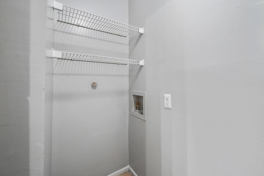 a walk in closet in a white room with a white wall and a white door at Ascot Place Apartments, Birmingham