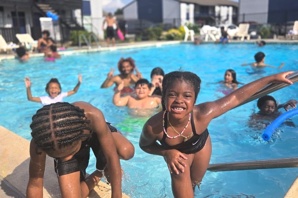 A group of people are enjoying a day at the pool.