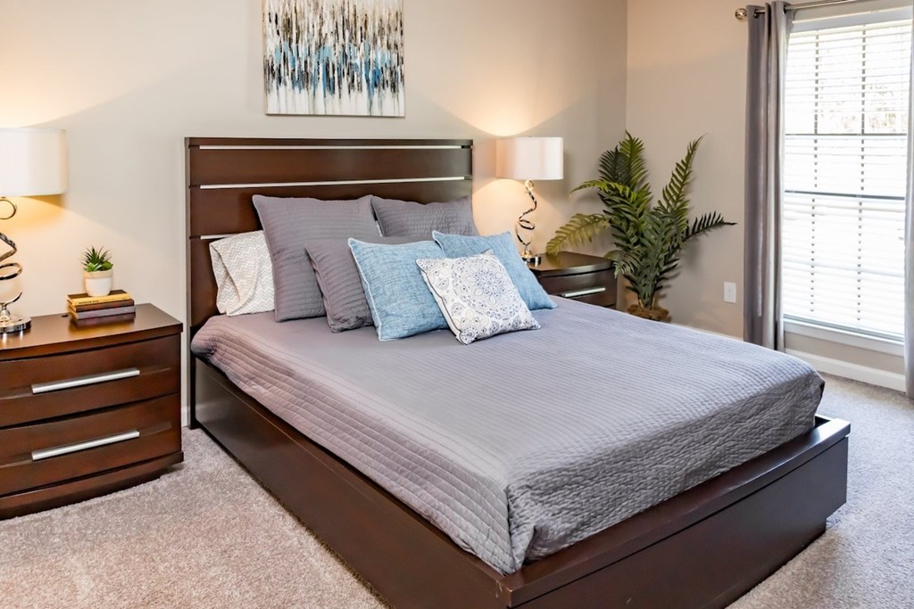 a bedroom with a bed and a dresser and a window a bedroom with a bed and a dresser and a window at Crestwood Green Apartments, Birmingham, 35212