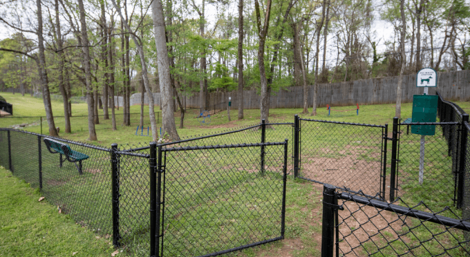 a black chain link fence is installed in a dog park at Crestwood Green, LLC, Birmingham, 35212