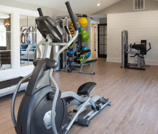 a gym with a lot of exercise equipment at Crestwood Green, LLC, Birmingham, AL 35212